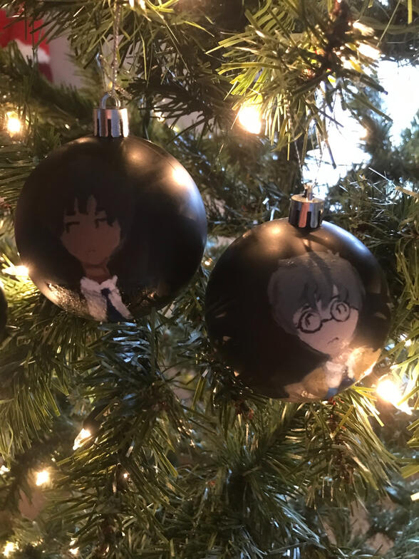 A painting of toya and yukito from cardcaptor sakura on a black ornament