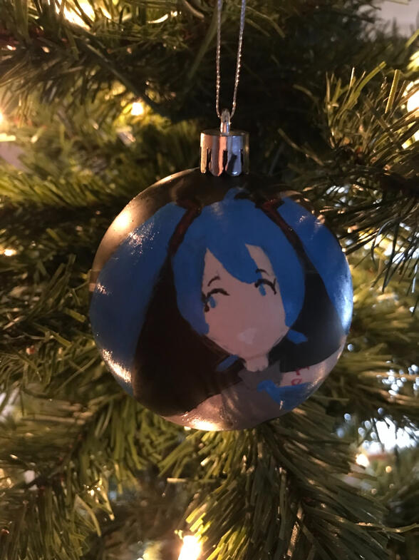 A painting of hatsune miku on a black ornament